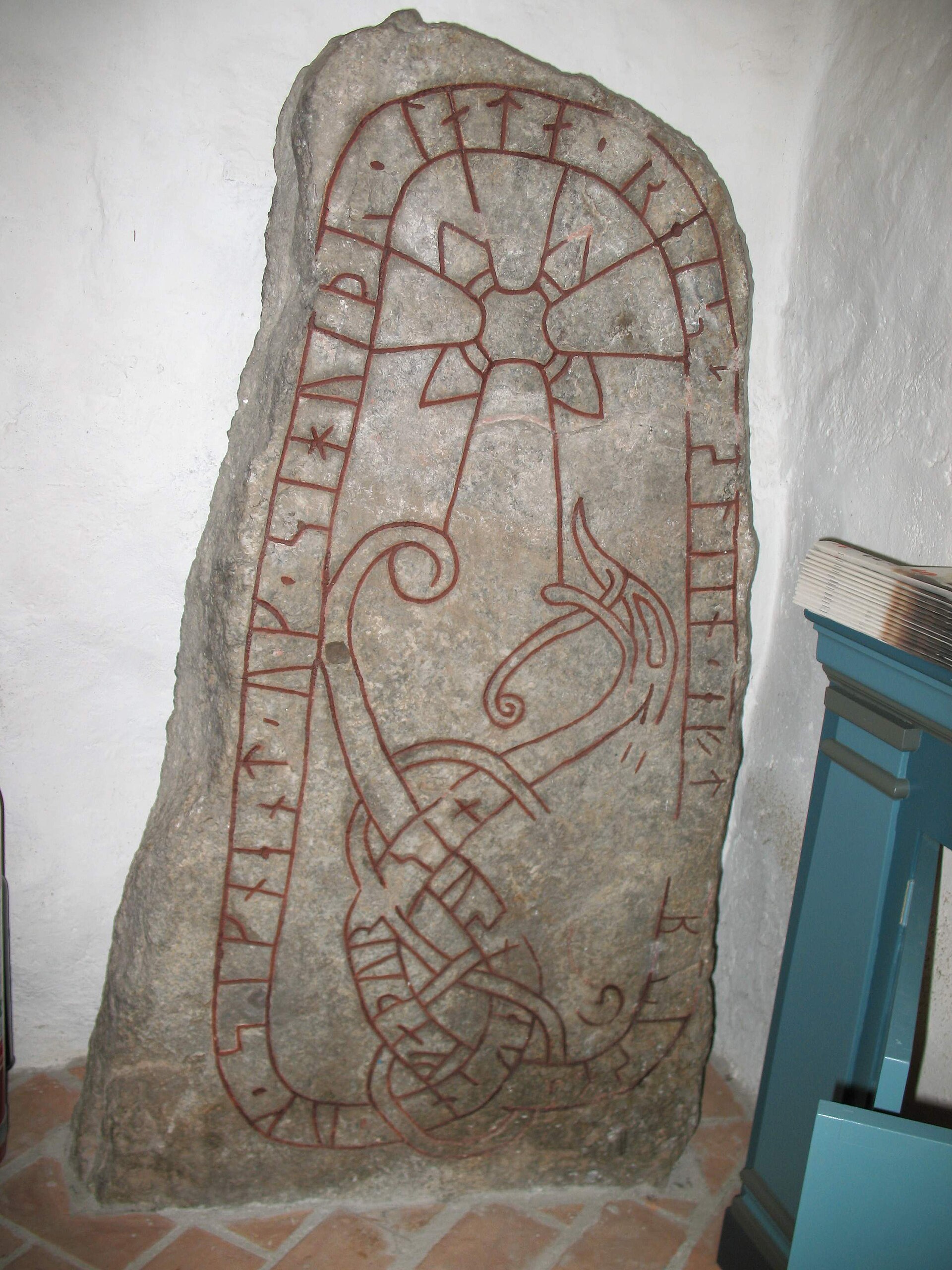 The rune-stone U 333 in Orkesta church, Orkesta parish, Vallentuna municipality. The run-stone translates: "Ósníkinn and Signjótr and Sigviðr have raised the stone in memory of Brúsi, their father."
